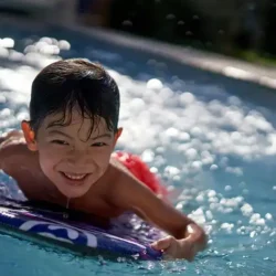 Children need a special approach to learning to surf. Image: Drew Gilliam